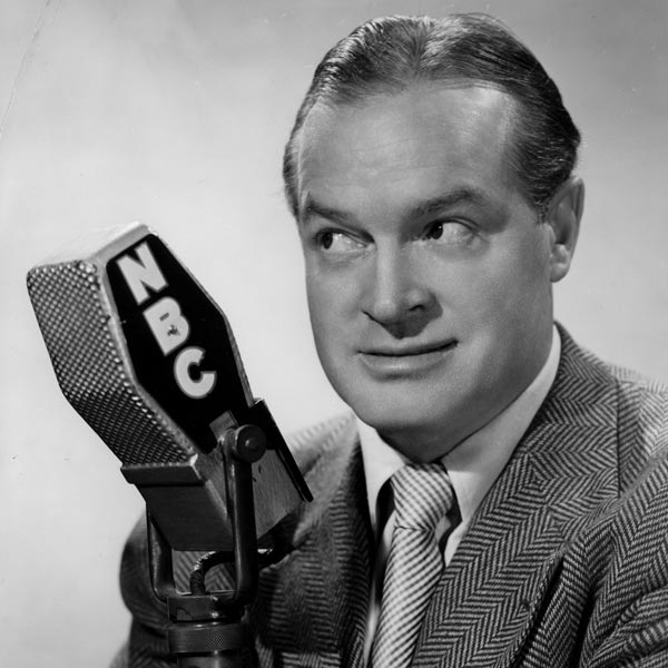 Bob Hope posing beside a microphone