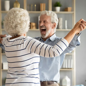 Elderly couple dancing to music